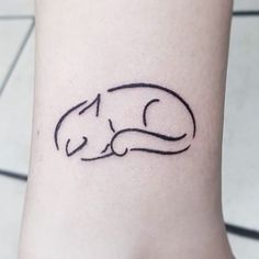 a small cat tattoo on the ankle that is black and white with a line drawing