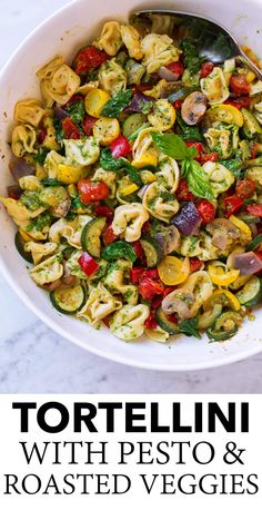 tortelli with pesto and roasted veggies in a white bowl