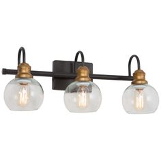 three light bathroom fixture with glass globes on the wall and an old - fashioned bronze finish