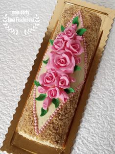 a decorated cake with pink roses on it