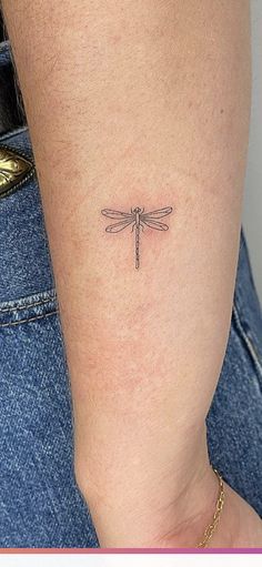 a small dragonfly tattoo on the ankle