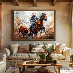 a living room filled with furniture and a large painting on the wall above it's coffee table