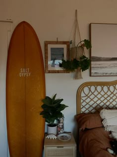 a bedroom with a surfboard on the wall next to a bed and nightstands