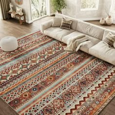 a living room with a large rug on the floor and couch in front of it