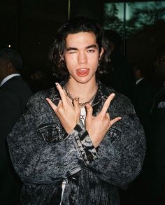 a young man making the vulcan sign with his hands