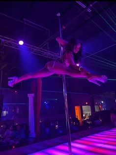 a pole dancer in the middle of a show