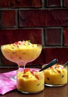 two small desserts are sitting on a table next to each other, one is yellow and the other is red