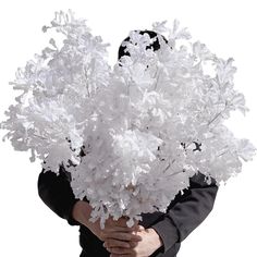 a person holding a bunch of white flowers