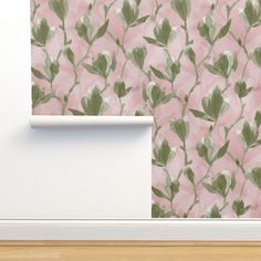 a pink wall with green leaves on it