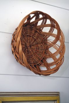 a basket hanging on the side of a wall