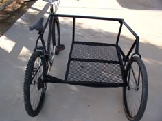 a bicycle is parked on the sidewalk next to a bike rack that has two bicycles in it