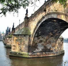 an old stone bridge over a body of water