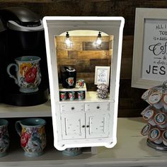 there is a small cabinet with coffee cups on it