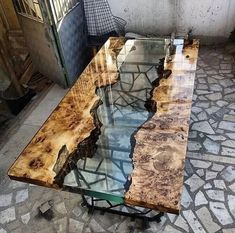 a table that has been made out of wood and glass on the outside of it