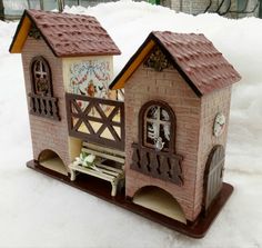 a toy house made out of clay in the snow