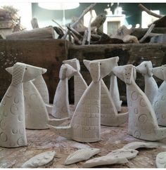 several white ceramic sculptures sitting on top of a table