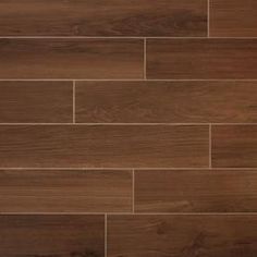 a close up view of a wood floor with dark brown tiles on the bottom and sides