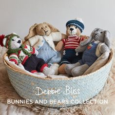 a basket filled with stuffed animals sitting on top of a fur covered floor next to a white wall