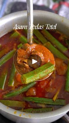 a bowl filled with stew and vegetables on top of a table