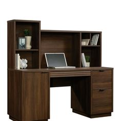 an office desk with open bookcases and a laptop computer on the top shelf