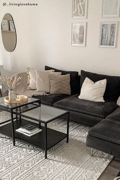 a living room with couches, tables and pictures hanging on the wall above them