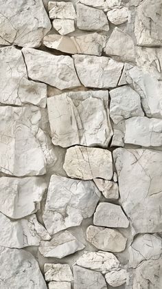 a stone wall with white rocks on it