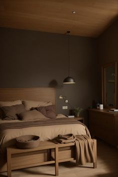 a bed sitting next to a wooden dresser in a bedroom on top of a hard wood floor