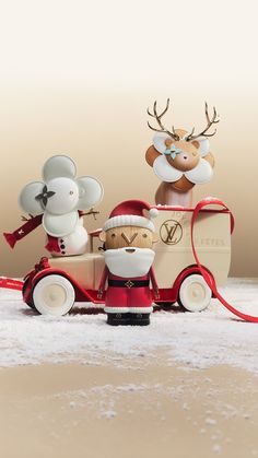 an old fashioned toy car with santa claus riding in the back and reindeer on top