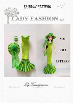 the doll is wearing a green dress and hat