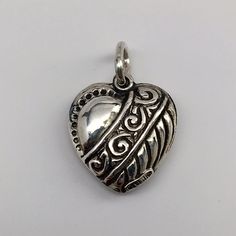 "This antiqued sterling silver, two-sided, repousse Puffy Heart Charm Number 7 features a Victorian geometric design of flowing musical clefs and whimsical triangles. Marked, Sterling. Made by Brown County Silver. Vintage and in new, never worn condition. Approximately 30 years old. 3/4\" high with jump ring. 1/2\" wide 1.1 grams approx. *Chain sold separately See more @ https://www.etsy.com/shop/brocosi" Rabbit Jewelry, Brown County, Puffy Heart Charms, Sterling Silver Heart Pendant, Heart Pendants, Disposable Plates, Food Jewelry, Theme Parties, Number 7