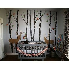 the baby's room is decorated with deer and trees