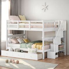 a white bunk bed with drawers underneath it in a child's room or bedroom