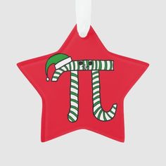 a red star shaped ornament with the letter t in green and white stripes