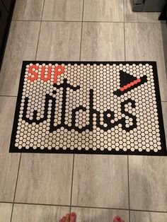 someone is standing on the floor with their feet in front of a sign that says stop witches