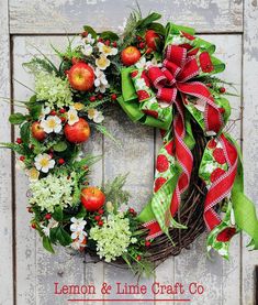 a wreath with apples and flowers on it