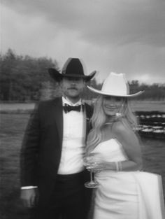 black and white photograph of a man and woman dressed up in formal wear standing next to each other