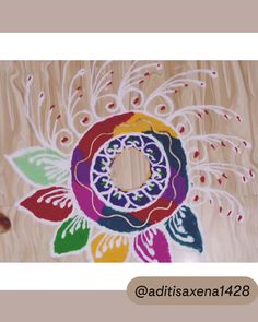 an artistically designed piece of wood with flowers and leaves painted on the bottom side