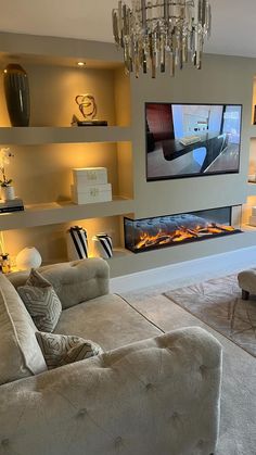 a living room filled with furniture and a flat screen tv mounted on the wall above it