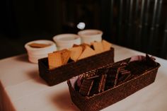 two baskets filled with chocolate chips sitting on top of a white tablecloth covered table