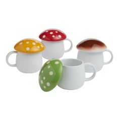 four coffee mugs with different designs on them