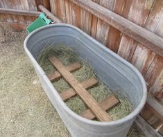 a bucket filled with hay and wooden crosses