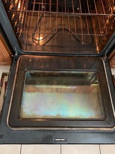 an oven door is open and it's still in the oven, but no one has any food inside