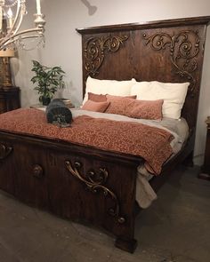 a bed with an ornate headboard and foot board is shown in this bedroom setting