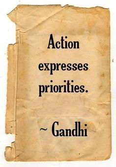 an old book with the words action expresses priorities gandhi