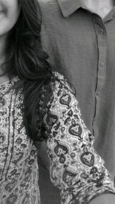 black and white photograph of a woman with her hand on her hip, smiling at the camera