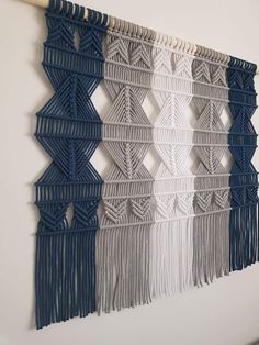 the wall hanging is made with yarn and wood