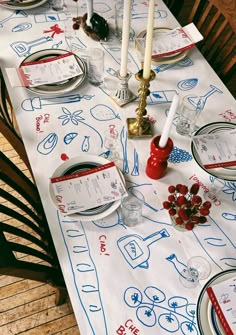 a table set with place settings and candles