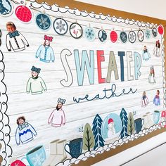 a sign that says sweater weather on the side of a wall with snowflakes