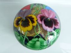 a glass ball with flowers painted on it