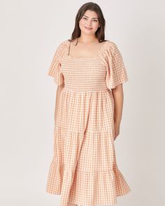 This beautiful tiered gingham print maxi dress is perfect for any occasion! It's designed with a squared neckline, smocking at the bodice and a self tie at back. This stunning piece will have you feeling like an absolute goddess! A must-have! Round out your vacation and weekend wardrobe with this plus size dress Polagram Gingham Tiered Maxi Dress | ORANGE | Dresses | Materials & Care Instructions: ['80% Polyester, 4% Spandex, 16% Rayon', 'Imported'] Plus Size Gingham Dress, Orange Gingham Dress, Spring Gingham Midi Dress With Square Neck, Gingham Dress With Ruffle Hem And Square Neck, Square Neck Tiered Dress With Smocked Back For Brunch, Square Neck Smocked Bodice Tiered Dress For Brunch, Dresses Materials, Orange Gingham, Squared Neckline